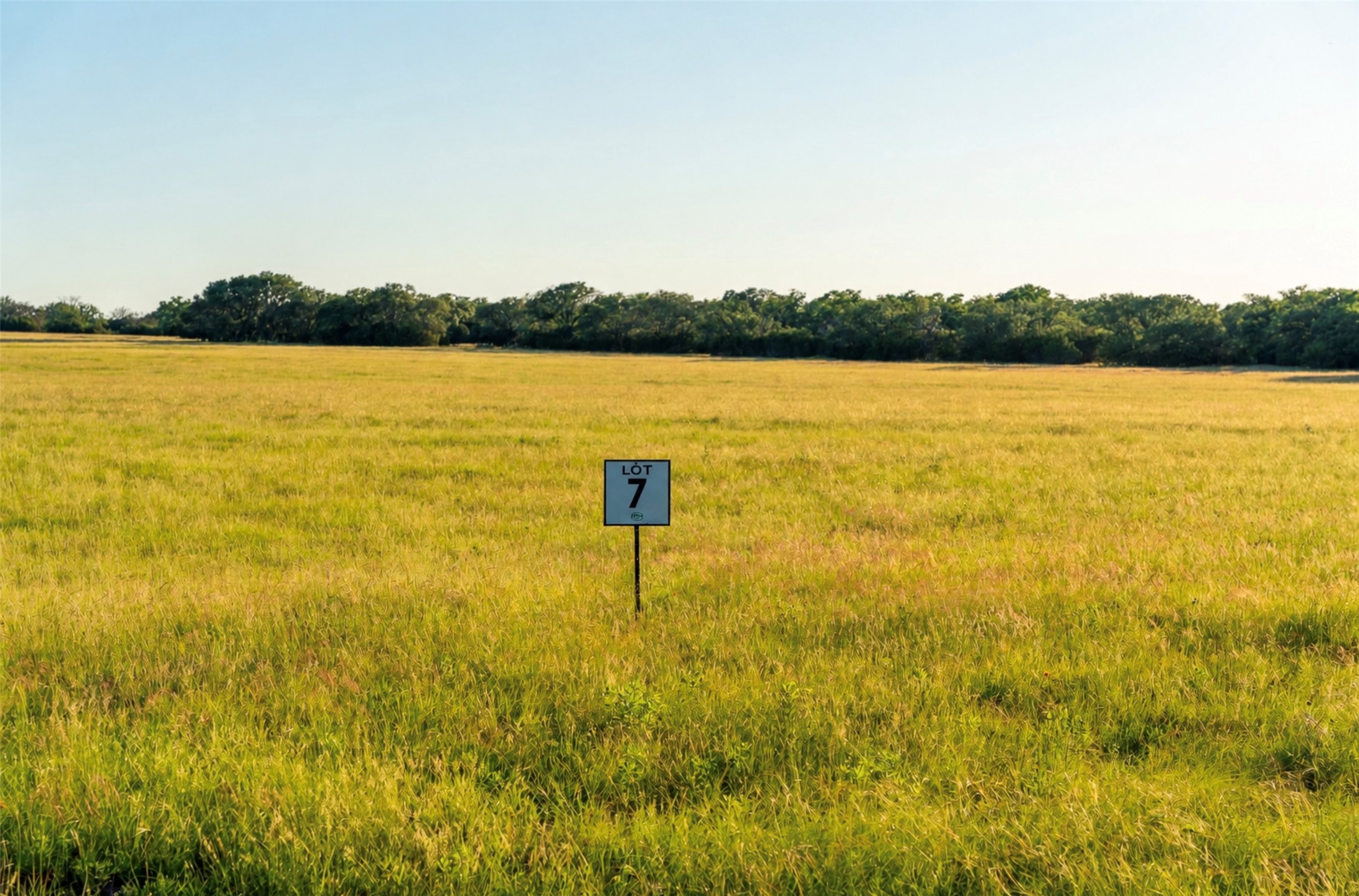 7 Feild Ranch Road Lampasas, TX 76550 - Photo 39 of 40 A spacious, undeveloped lot with verdant grasslands and a clear sky awaits your vision.