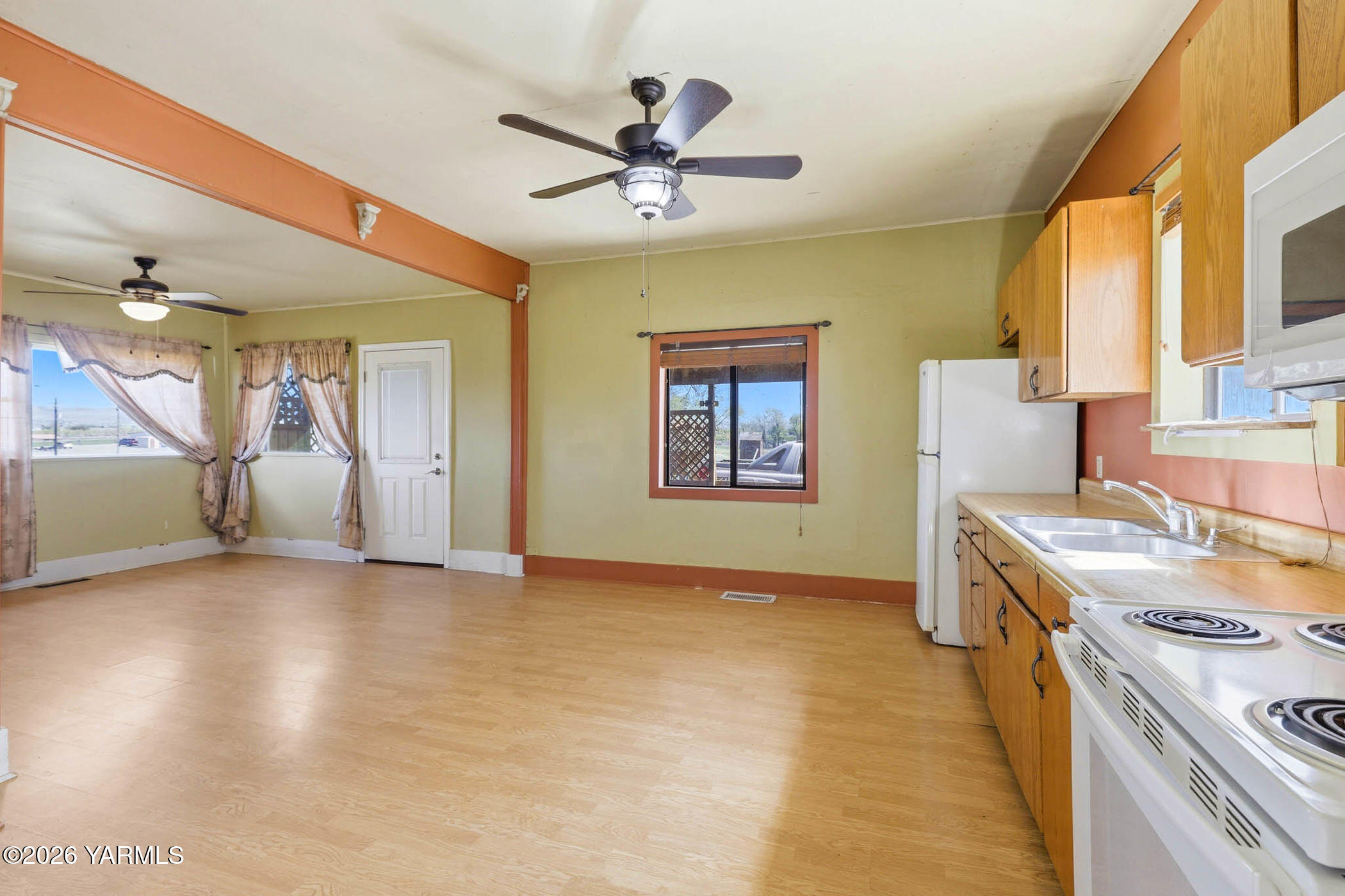 721 Blaine Road Granger, WA 98932 - Photo 10 of 45 a view of a kitchen with a sink and a stove top oven