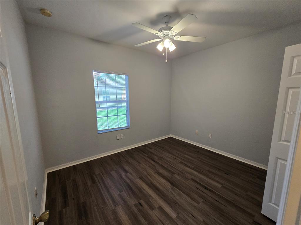 7976 48 Way Gainesville, FL 32653 - Photo 13 of 26 a view of an empty room with wooden floor and a window