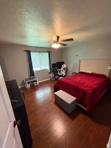 338 South 370 West Logan, UT 84321 - Photo 24 of 33 Bedroom featuring wood-finish flooring, a ceiling fan, window with blinds and dark curtains, and a light-colored headboard