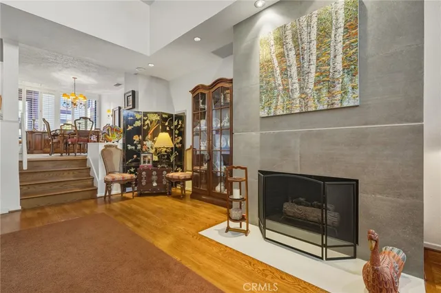 a living room with furniture a fireplace and gym equipment
