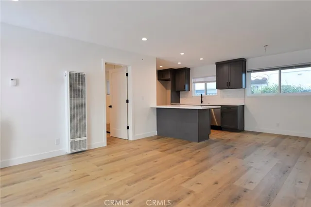 a view of kitchen with wooden floor and electronic appliances