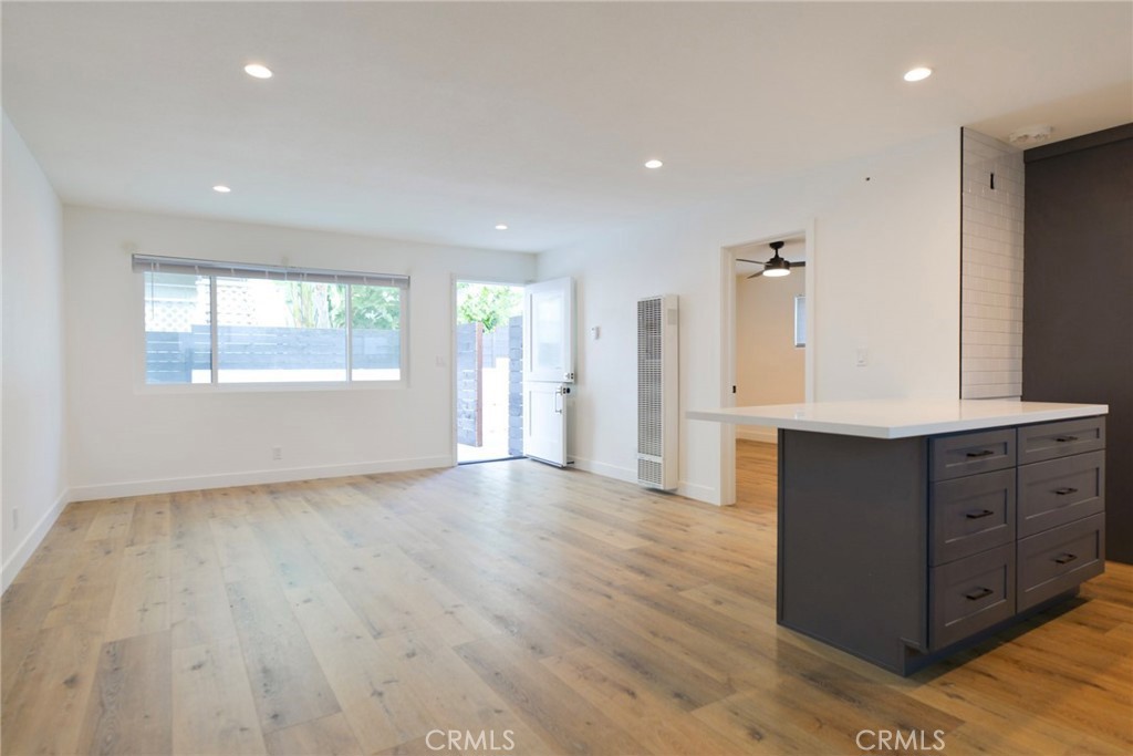 223 Avenida De La Grulla, Unit B San Clemente, CA 92672 - Photo 4 of 11 an empty room with wooden floor and windows