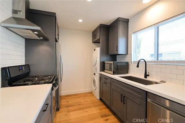 a kitchen with stainless steel appliances a sink stove and a refrigerator