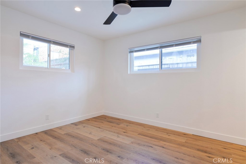 223 Avenida De La Grulla, Unit B San Clemente, CA 92672 - Photo 8 of 11 wooden floor in an empty room with a window