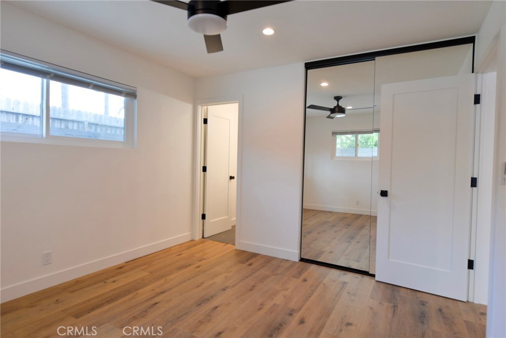 223 Avenida De La Grulla, Unit B San Clemente, CA 92672 - Photo 9 of 11 an empty room with wooden floor and windows
