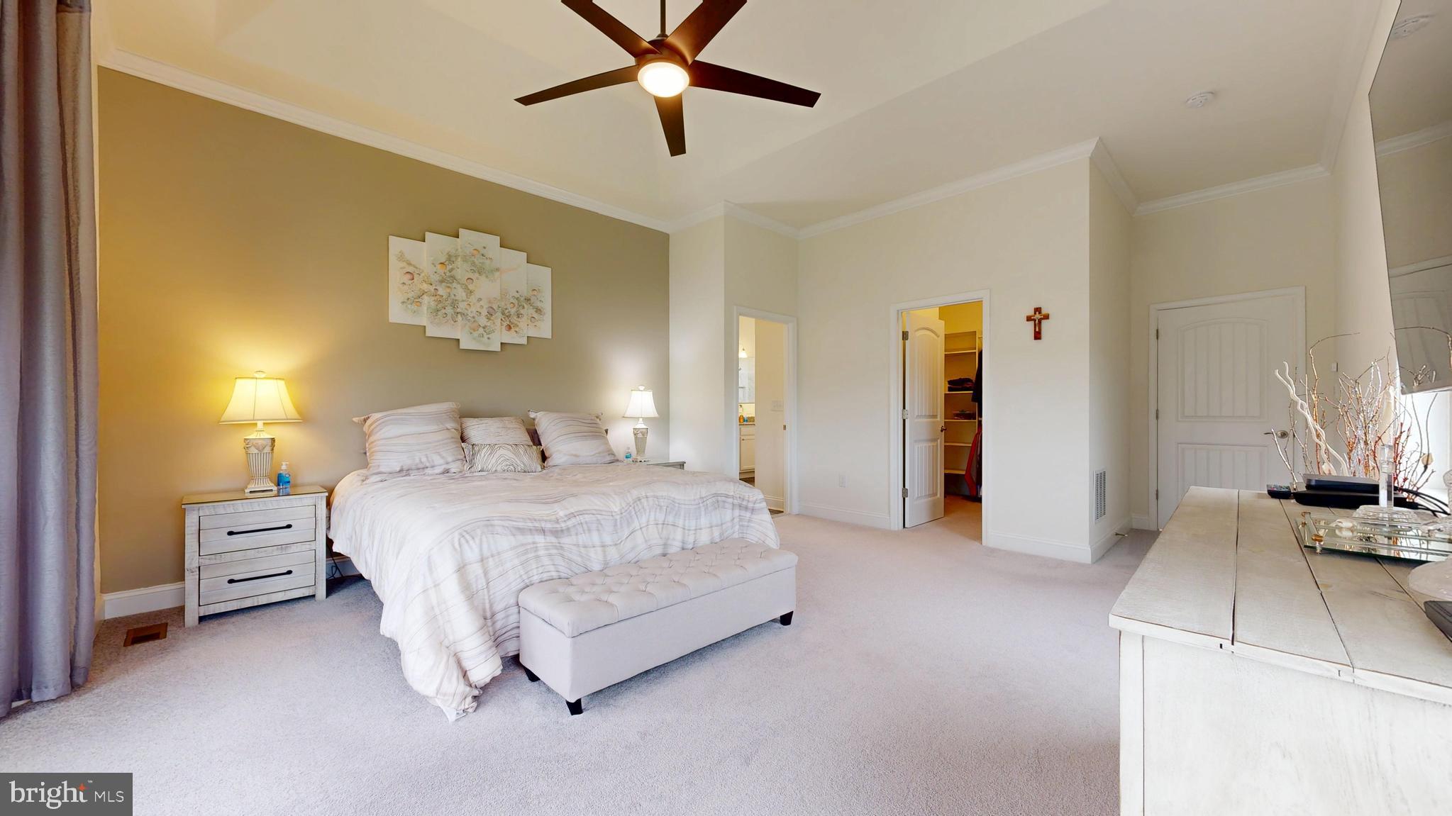 33528 Downing Circle Lewes, DE 19958 - Photo 32 of 72 a bedroom with a bed and a chandelier