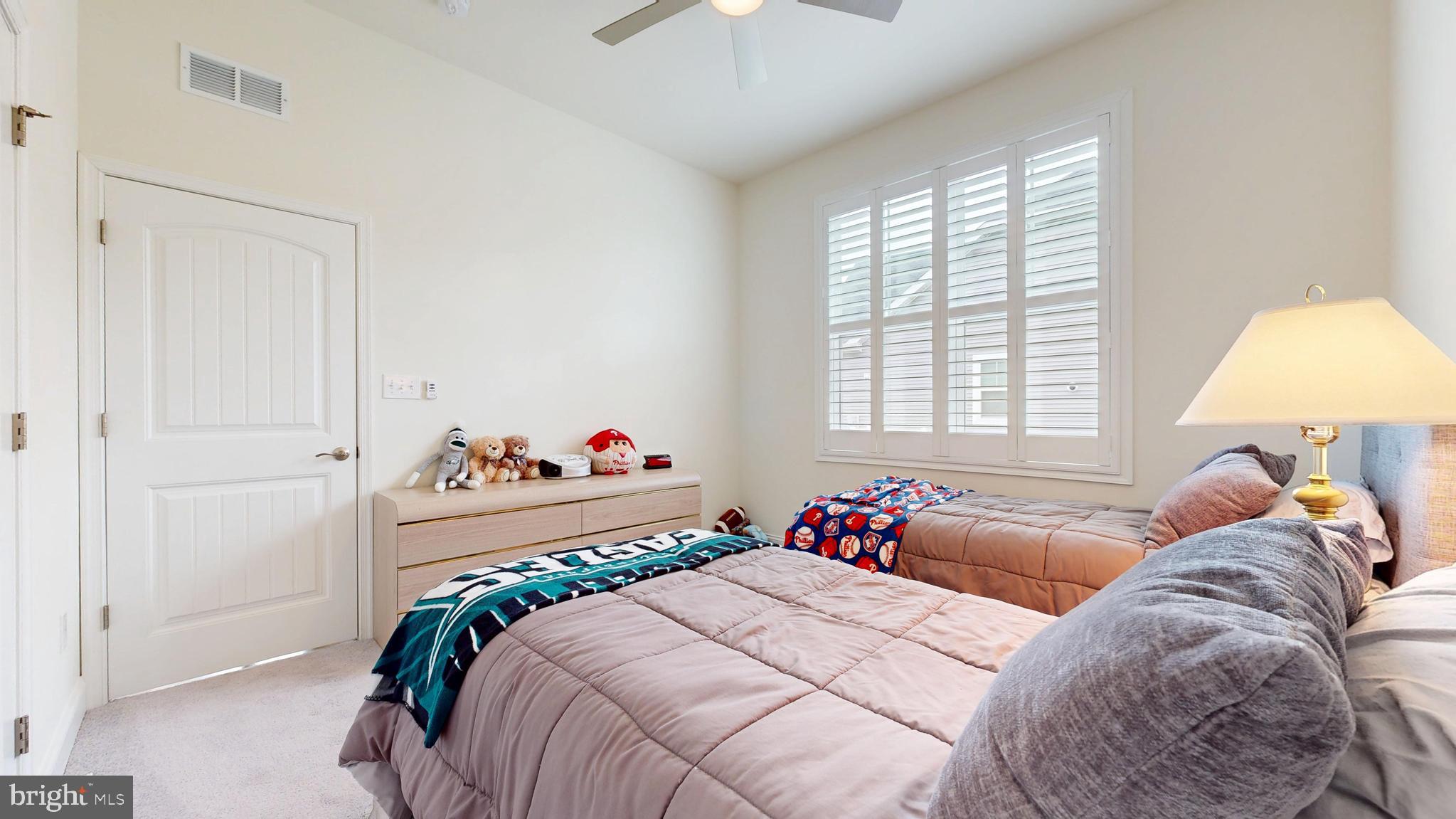 33528 Downing Circle Lewes, DE 19958 - Photo 39 of 72 a bed room with a bed and a chandelier