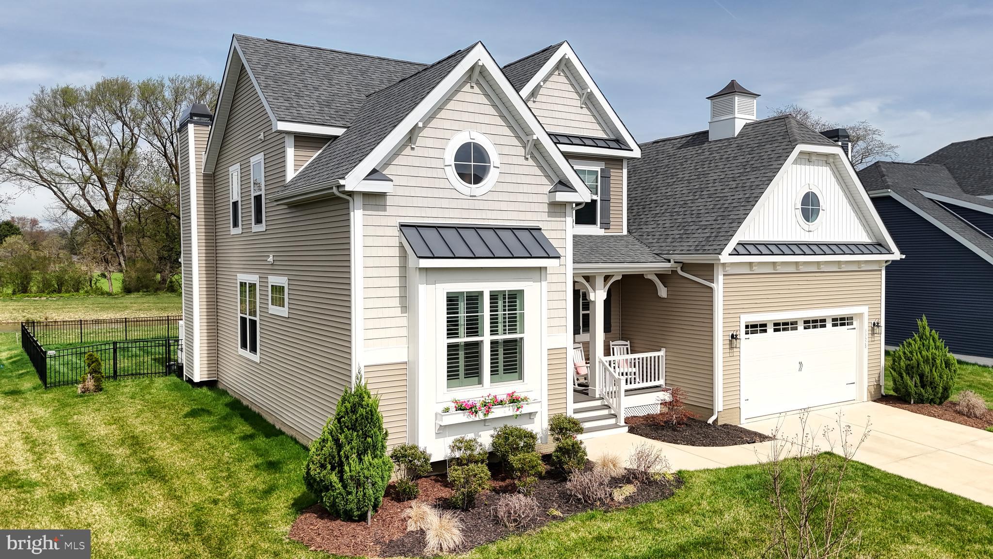 33528 Downing Circle Lewes, DE 19958 - Photo 4 of 72 a front view of a house with a yard