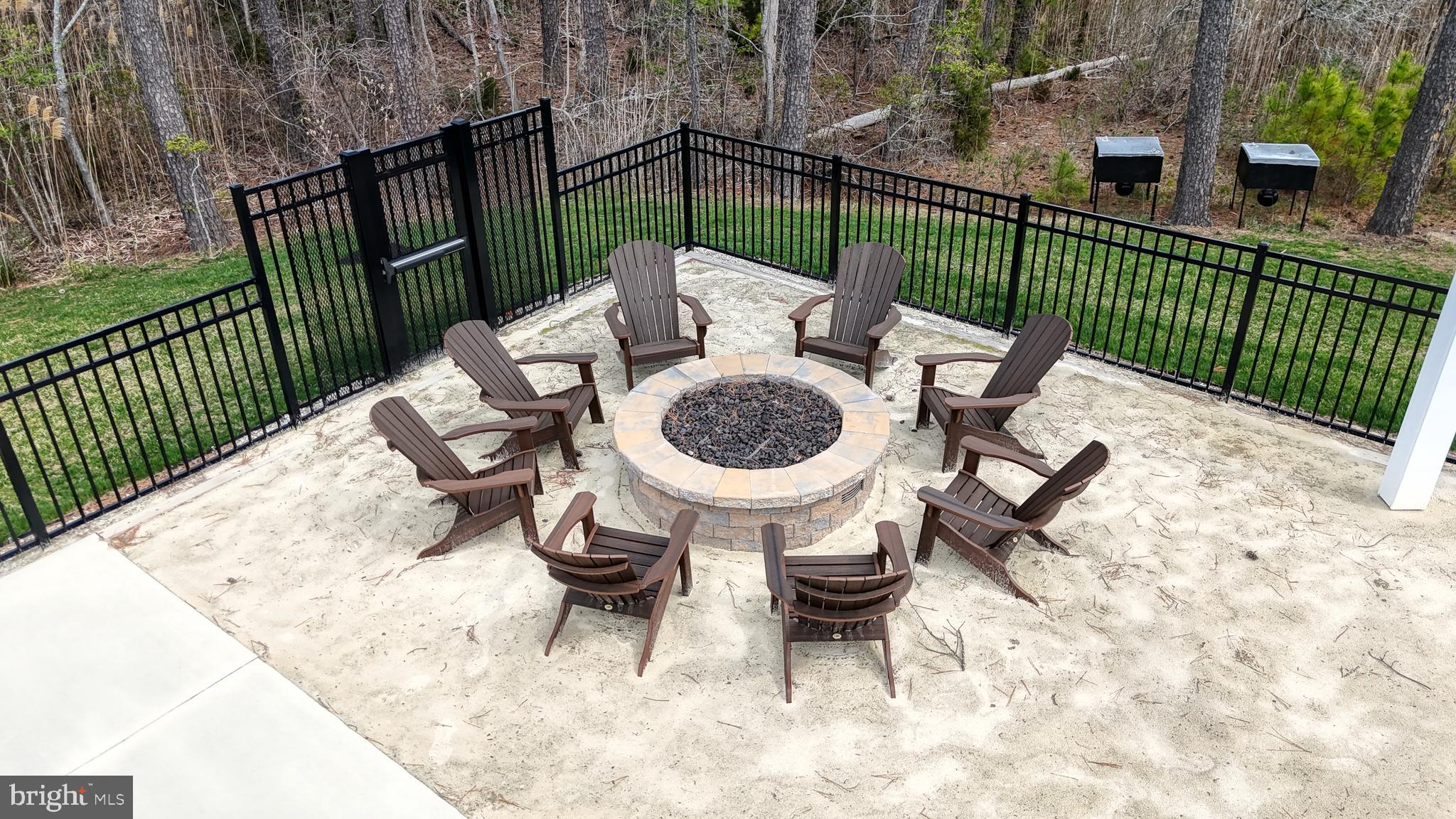 33528 Downing Circle Lewes, DE 19958 - Photo 63 of 72 a view of a patio with a table chairs and a small yard