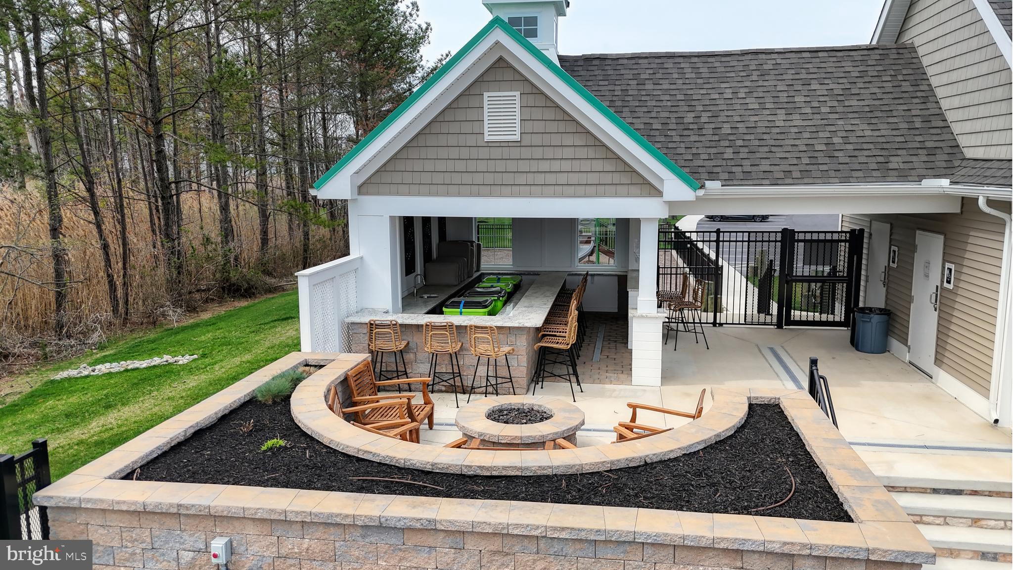 33528 Downing Circle Lewes, DE 19958 - Photo 65 of 72 Firepit and bar by the clubhouse/pool