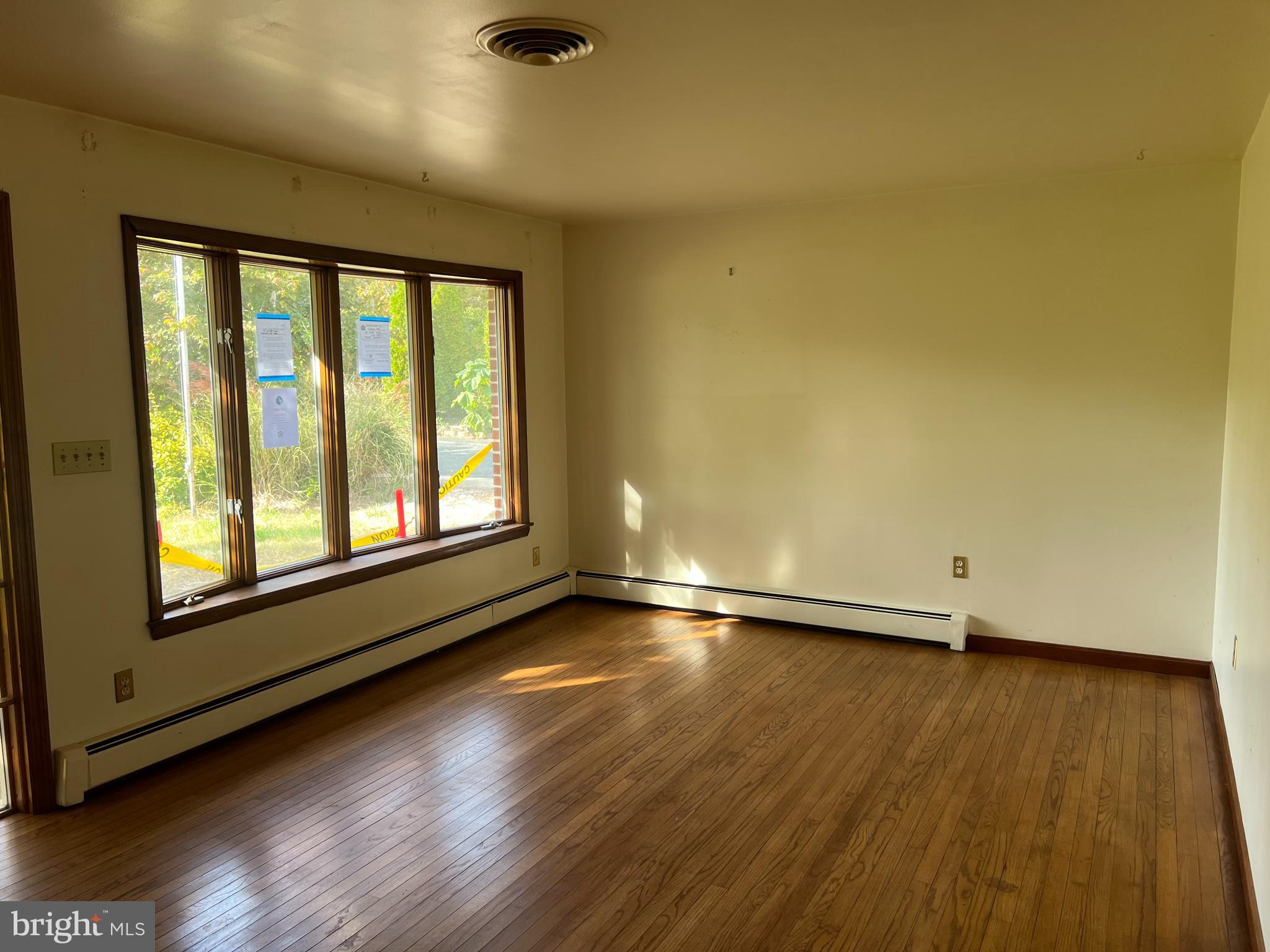 2427 Rocks Road Forest Hill, MD 21050 - Photo 7 of 23 an empty room with wooden floor and windows