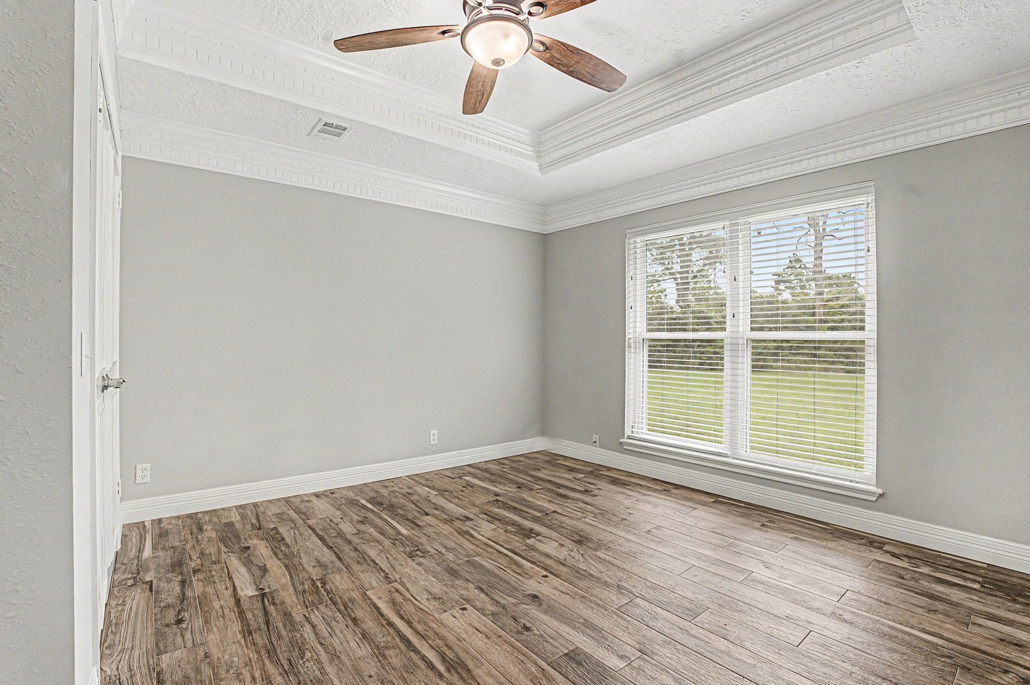 35564 Brumlow Road Hempstead, TX 77445 - Photo 19 of 46 a view of an empty room with wooden floor and a window