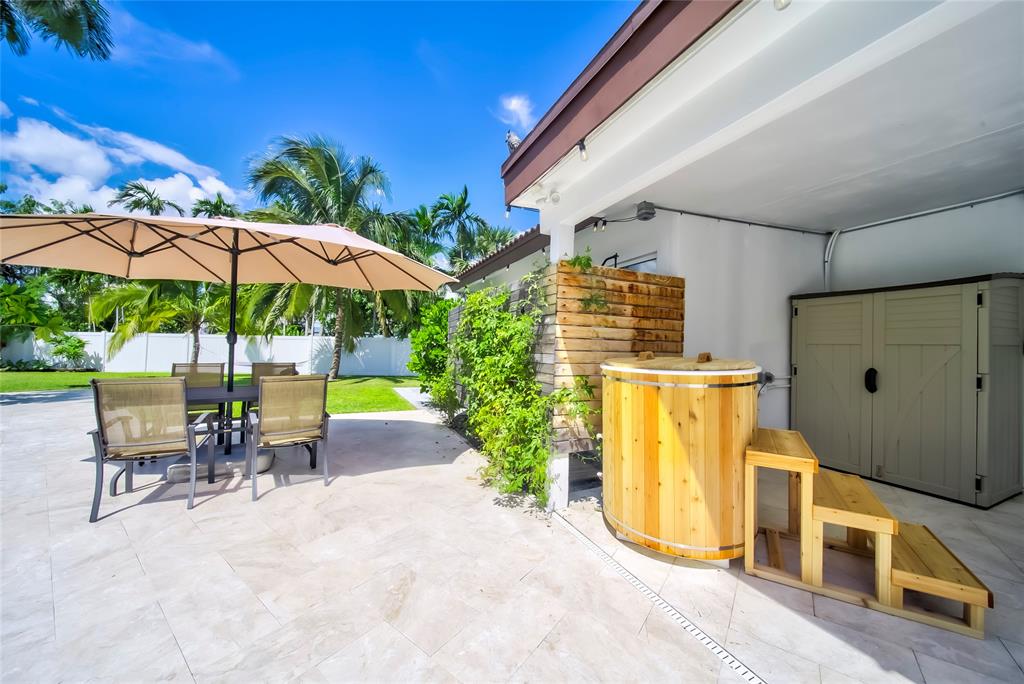 250 Northeast 27th Court Boca Raton, FL 33431 - Photo 16 of 29 a view of a patio with a table and chairs under an umbrella