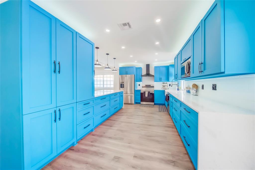 250 Northeast 27th Court Boca Raton, FL 33431 - Photo 23 of 29 a kitchen with stainless steel appliances granite countertop wooden cabinets a sink and a stove