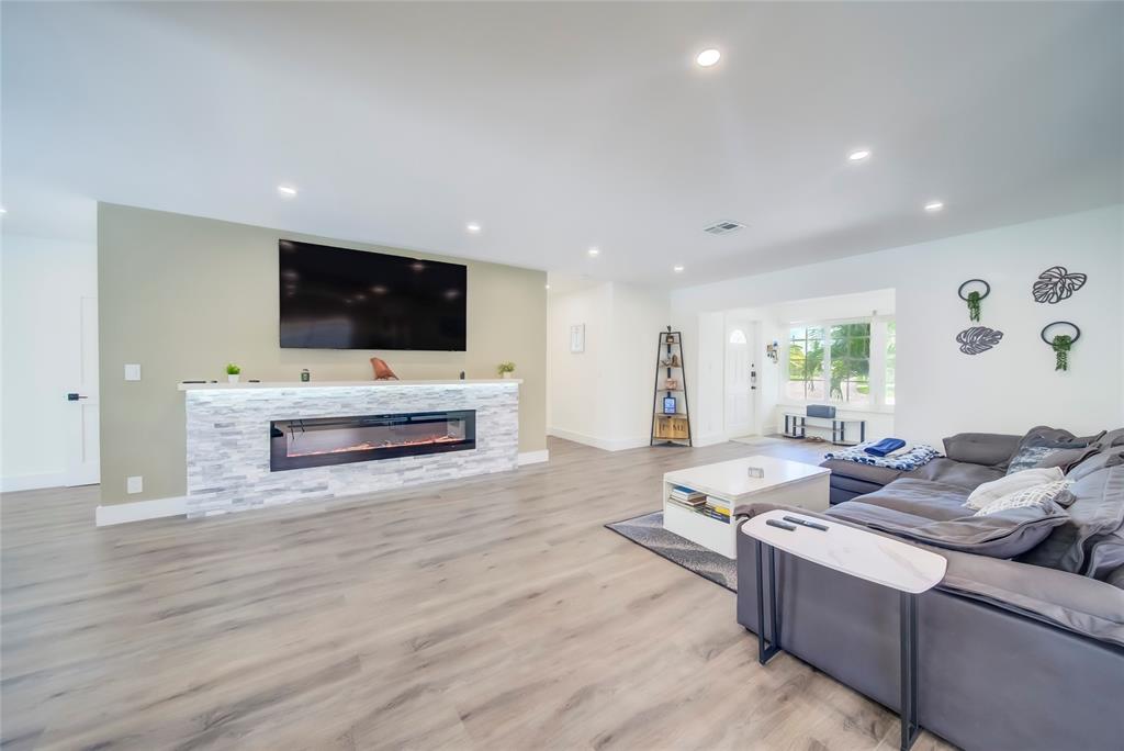 250 Northeast 27th Court Boca Raton, FL 33431 - Photo 28 of 29 a living room with fireplace furniture and a flat screen tv