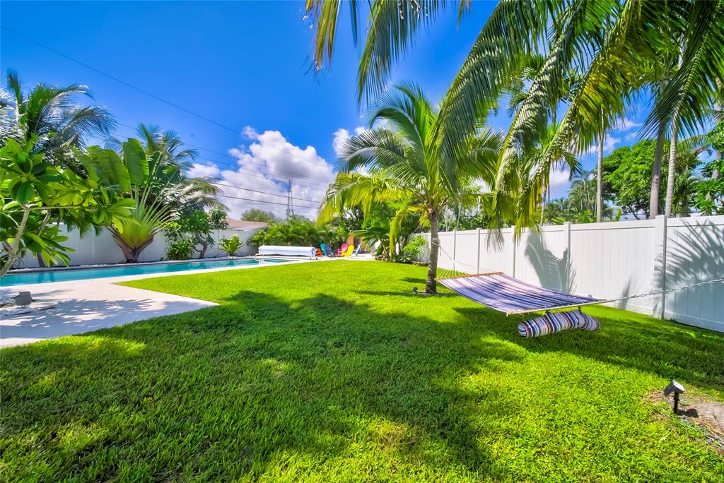 250 Northeast 27th Court Boca Raton, FL 33431 - Photo 8 of 29 a view of a swimming pool with a yard