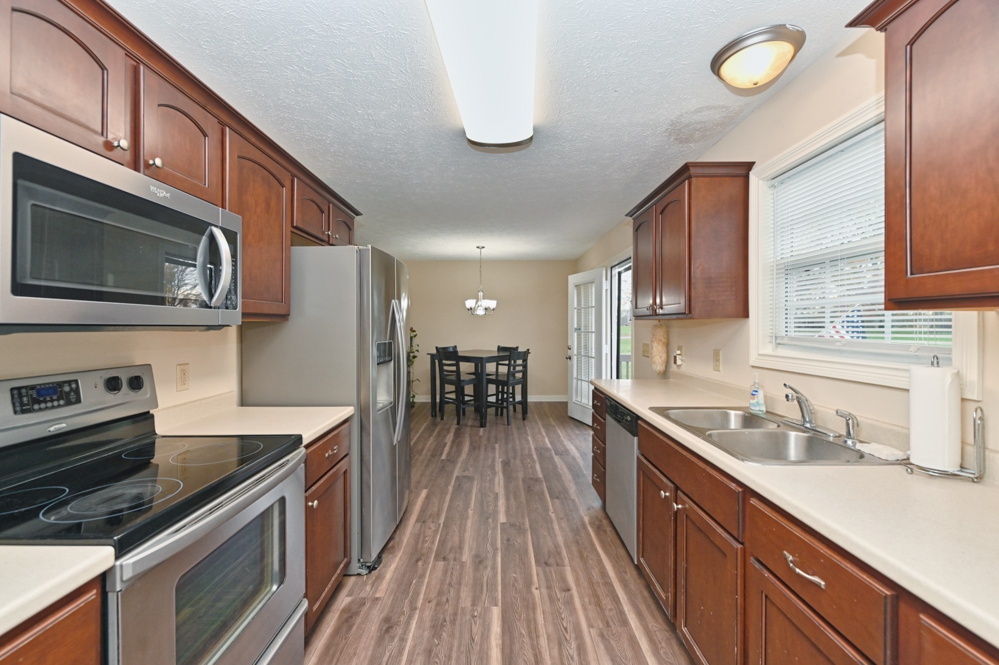 134 T G T Road Portland, TN 37148 - Photo 11 of 27 a kitchen with stainless steel appliances granite countertop a sink stove and refrigerator