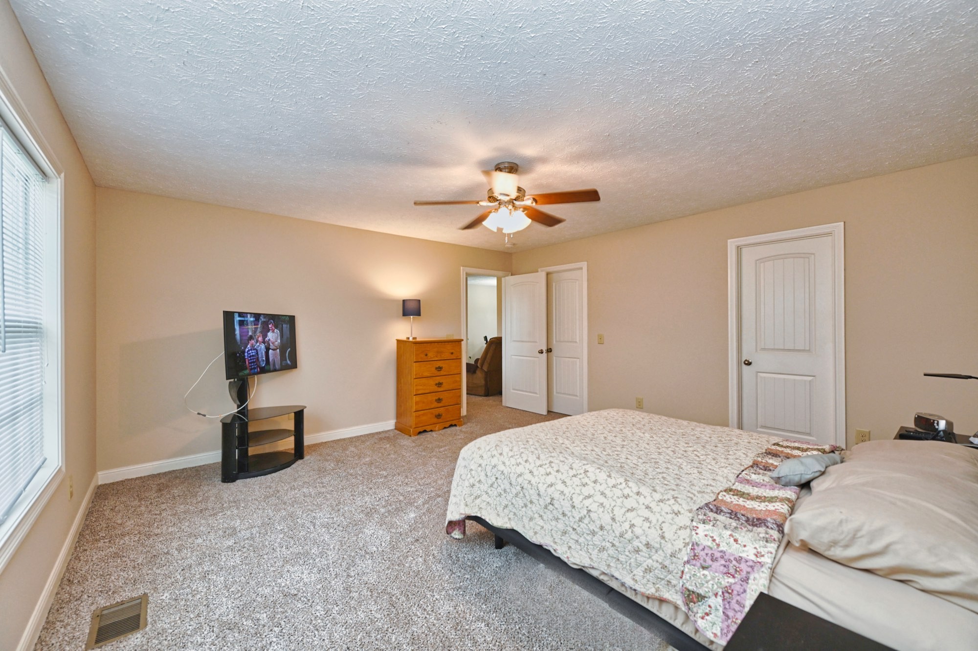 134 T G T Road Portland, TN 37148 - Photo 18 of 27 a bedroom with a bed and a chandelier