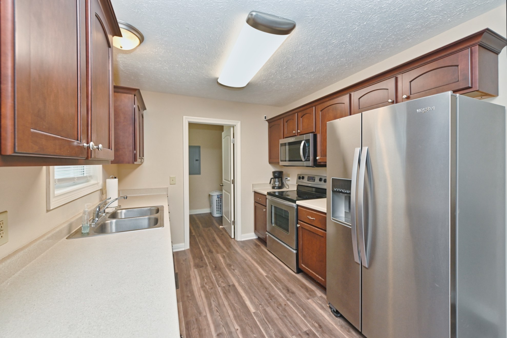 134 T G T Road Portland, TN 37148 - Photo 9 of 27 a kitchen with granite countertop a refrigerator stove and sink