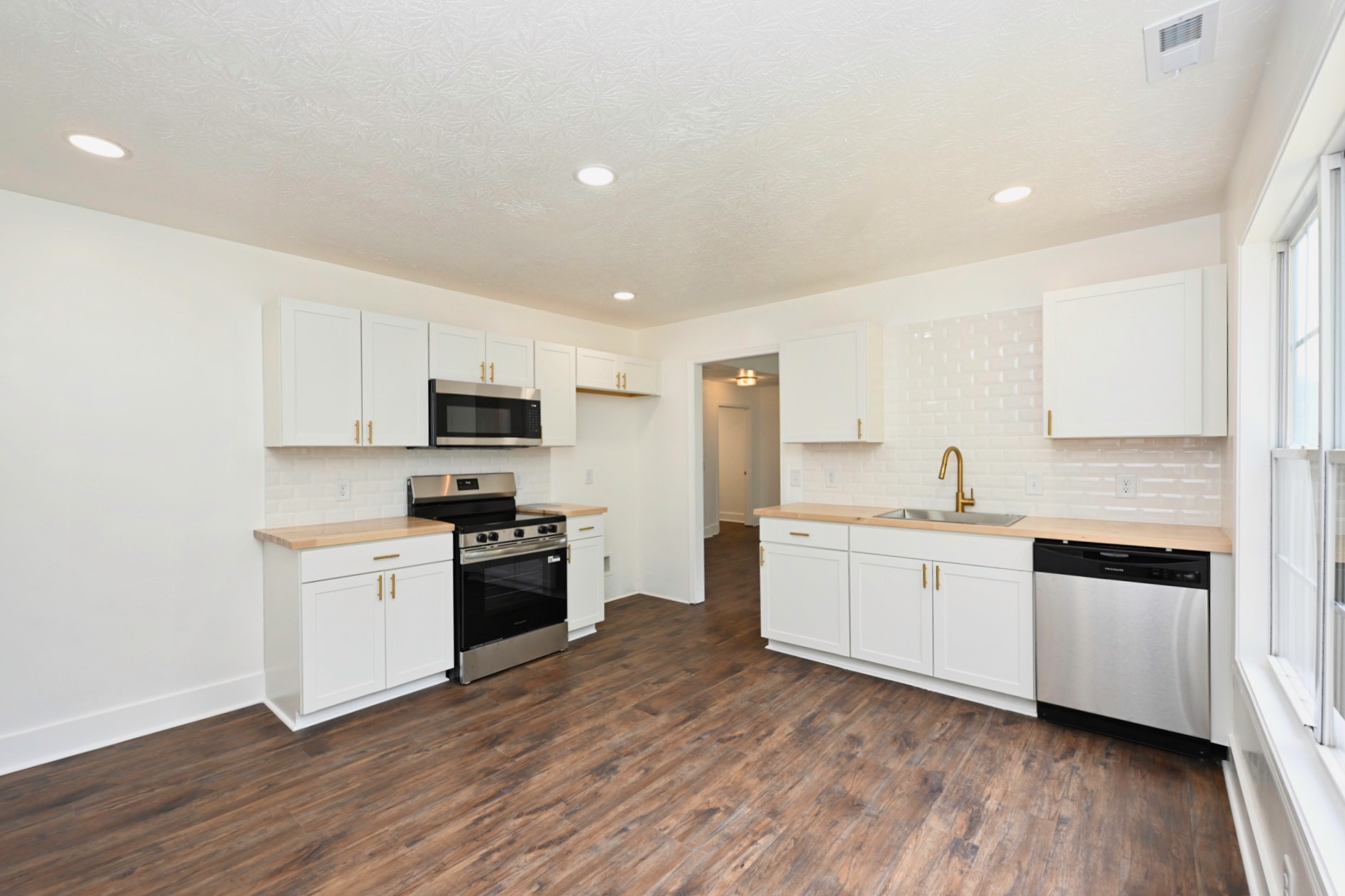 200 Larkin Springs Road Madison, TN 37115 - Photo 56 of 89 a kitchen with granite countertop white cabinets and stainless steel appliances
