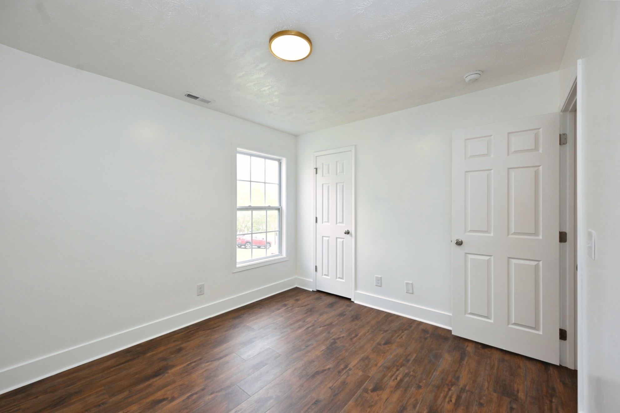 200 Larkin Springs Road Madison, TN 37115 - Photo 76 of 89 an empty room with wooden floor and window
