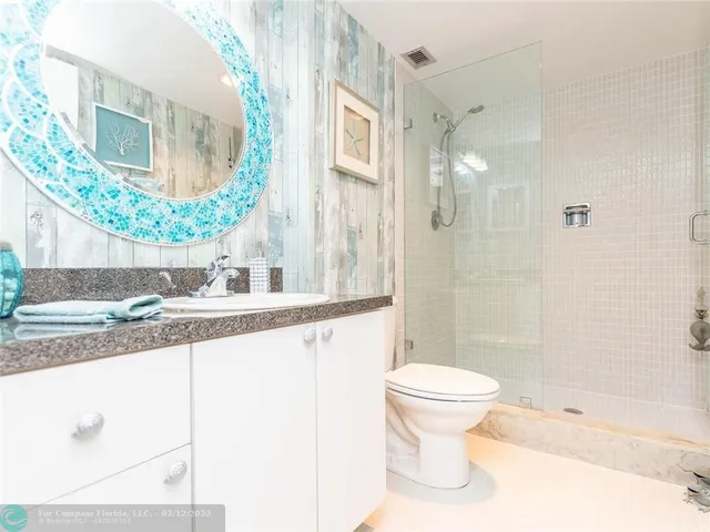 a view of a swimming pool with a chair and tables