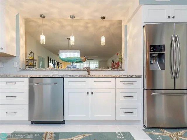 a kitchen with a refrigerator and a sink