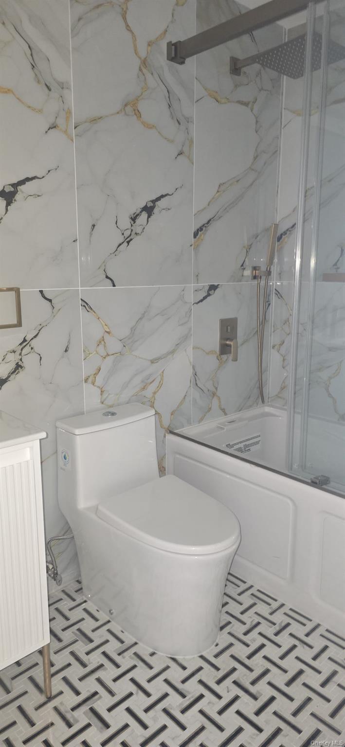 108-33 164th Street Queens, NY 11433 - Photo 20 of 20 a white toilet sitting next to a bathtub