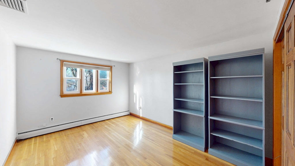 13 West Street Woburn, MA 01801 - Photo 12 of 30 a view of an empty room with a window and wooden floor