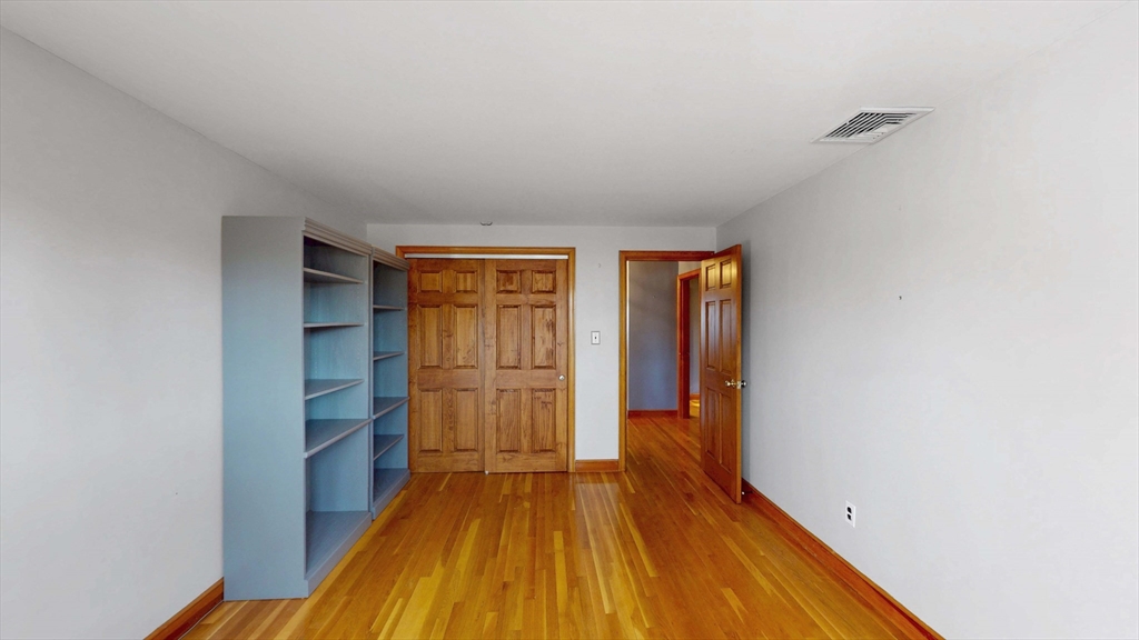 13 West Street Woburn, MA 01801 - Photo 13 of 30 a view of empty room with wooden floor and fan