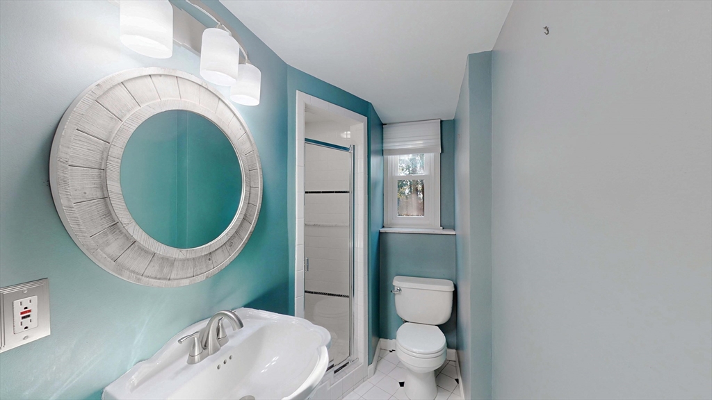 13 West Street Woburn, MA 01801 - Photo 19 of 30 a bathroom with a toilet mirror and vanity