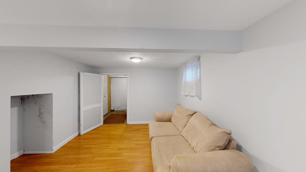 13 West Street Woburn, MA 01801 - Photo 21 of 30 a bedroom with a bed and a couch