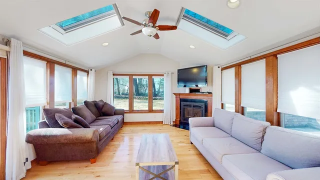 a living room with furniture fireplace and flat screen tv