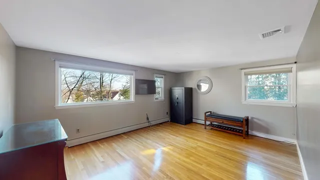 a view of room with window and wooden floor