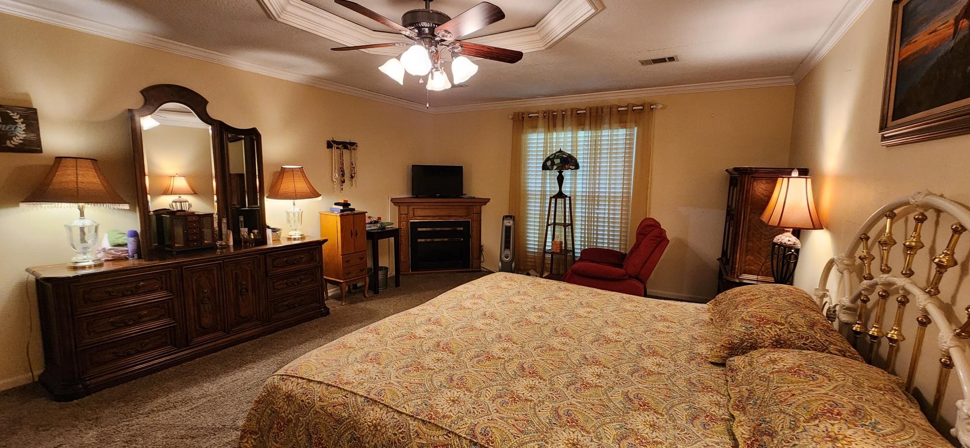 16155 Hexham Drive Spring, TX 77379 - Photo 25 of 47 a bedroom with a bed a dresser and flat screen tv