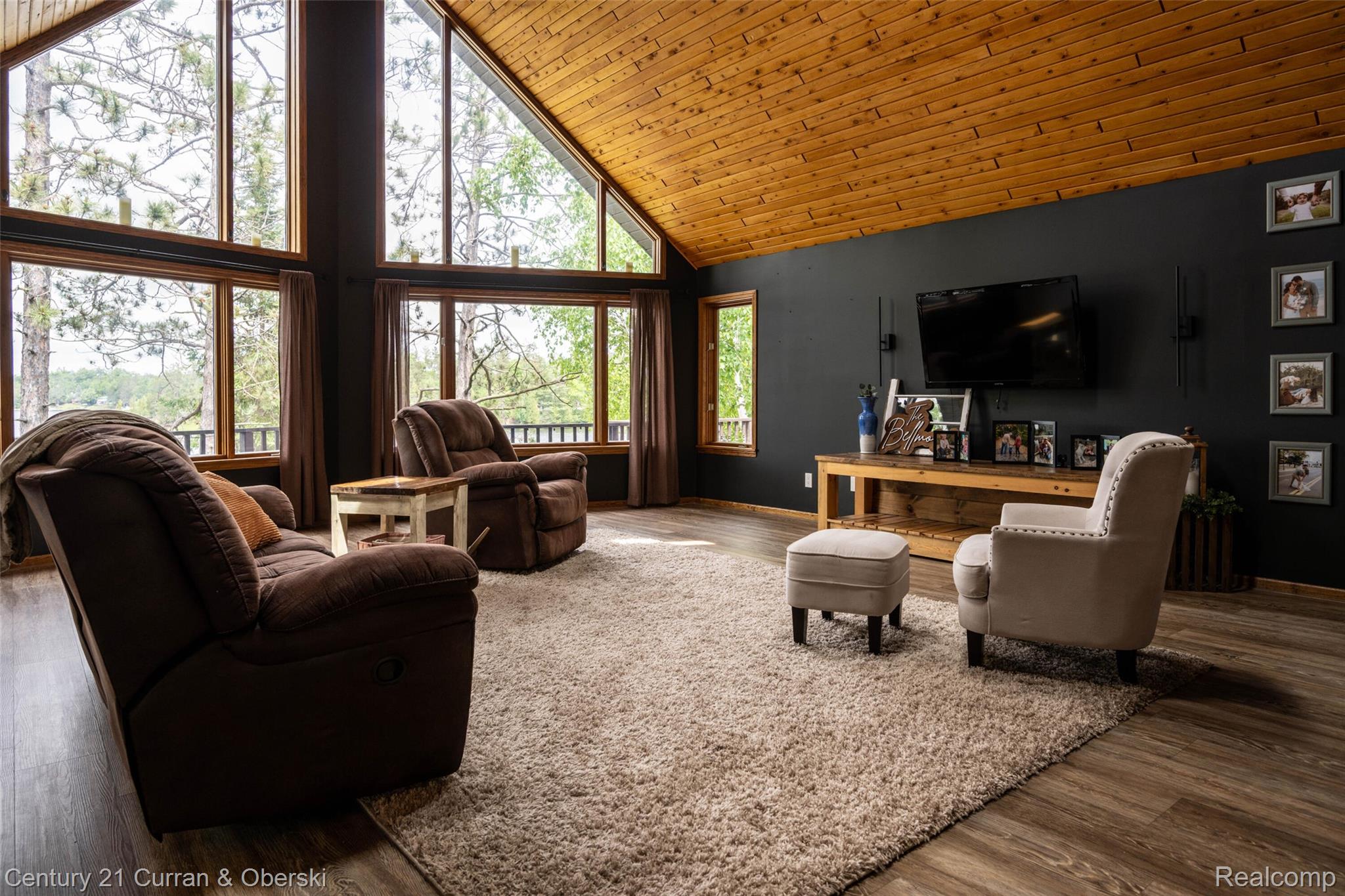 8775 Winding Rdg Drive Millersburg, MI 49759 - Photo 20 of 53 Vaulted wood-paneled ceilings over a spacious living area featuring abundant natural light from large windows