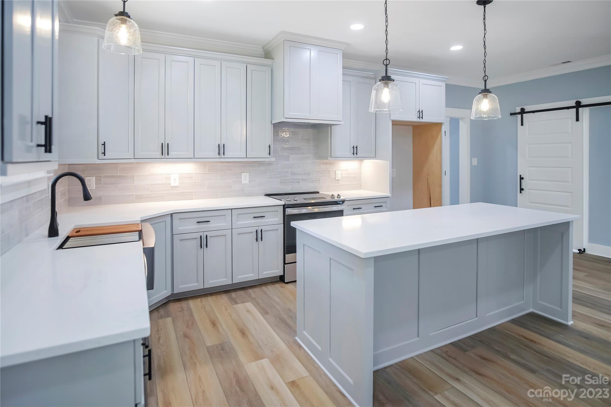 7550 Webbs Road Denver, NC 28037 - Photo 16 of 46 a kitchen with kitchen island a sink stainless steel appliances and cabinets