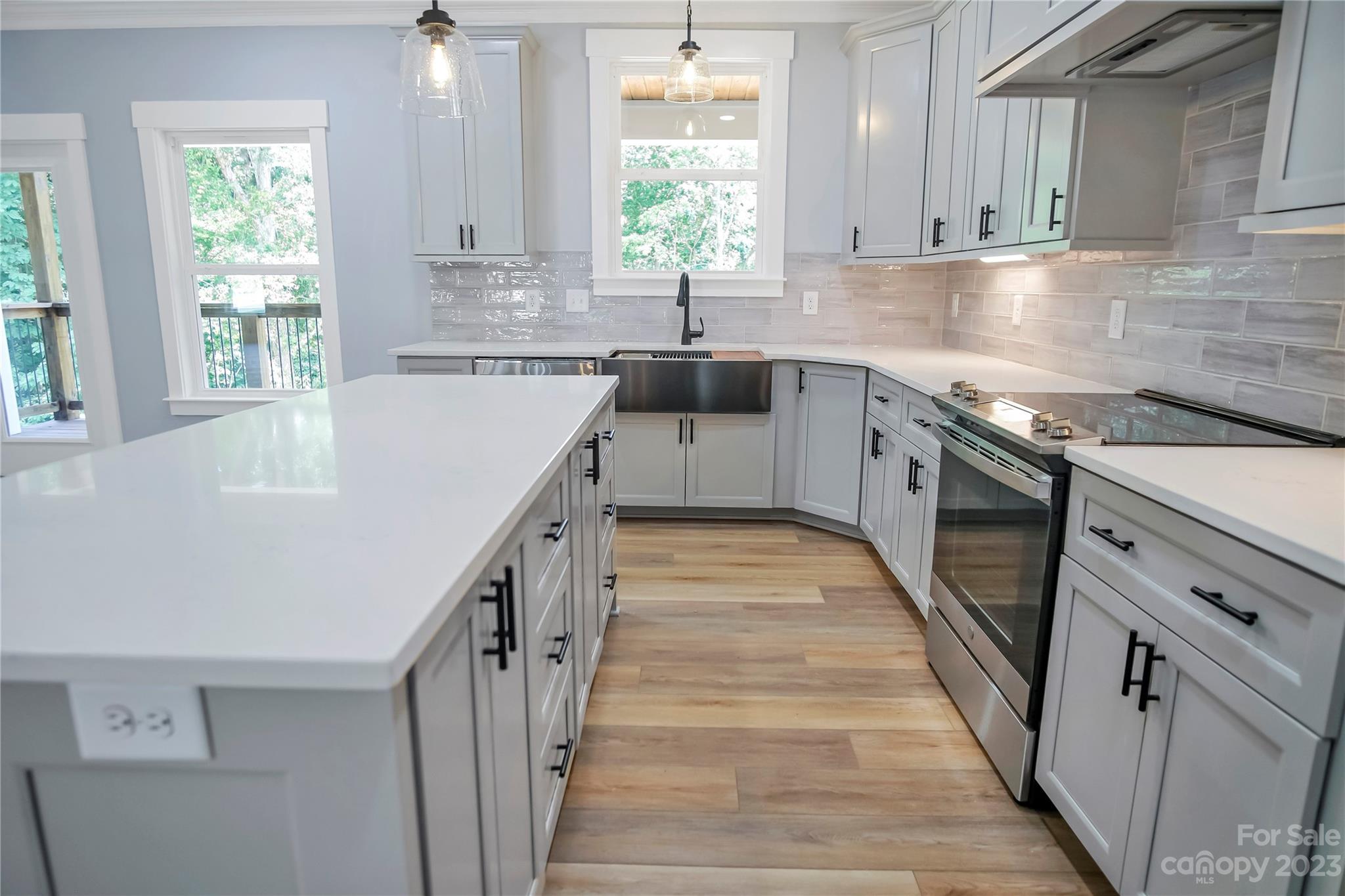 7550 Webbs Road Denver, NC 28037 - Photo 18 of 46 a kitchen with granite countertop a sink a counter space appliances and cabinets