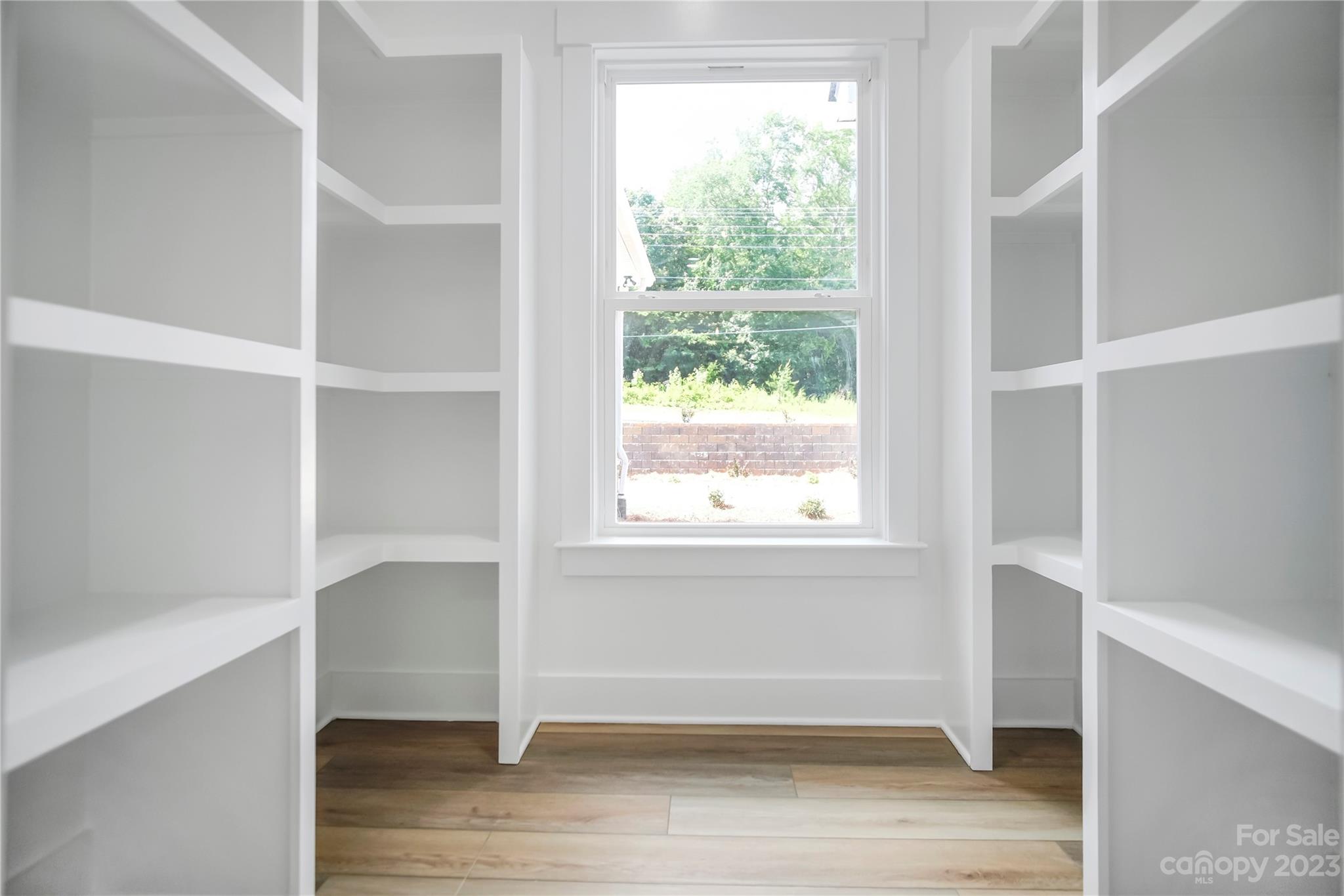 7550 Webbs Road Denver, NC 28037 - Photo 21 of 46 a view of an empty room with wooden floor and a window