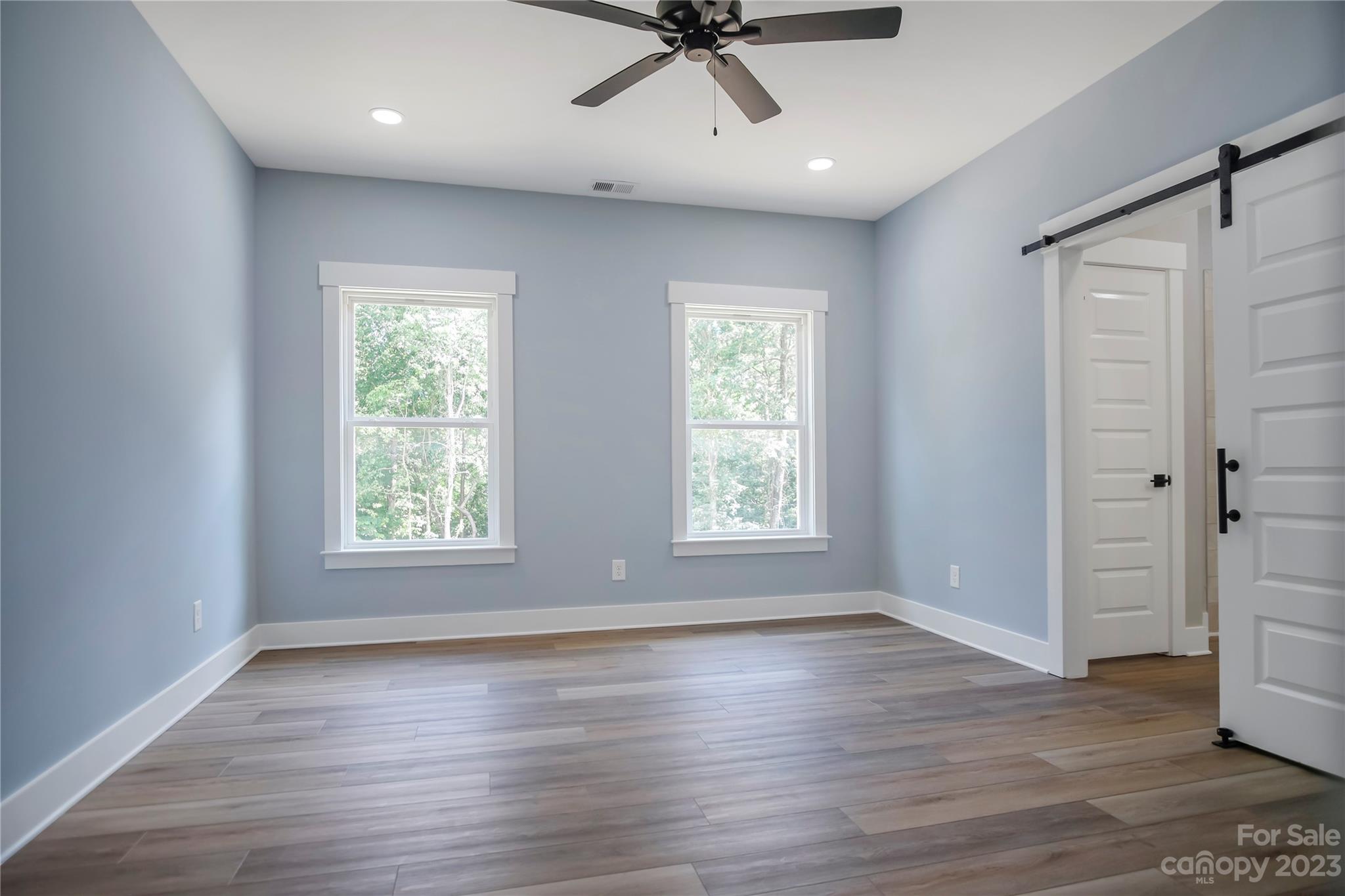 7550 Webbs Road Denver, NC 28037 - Photo 24 of 46 an empty room with wooden floor closet and windows