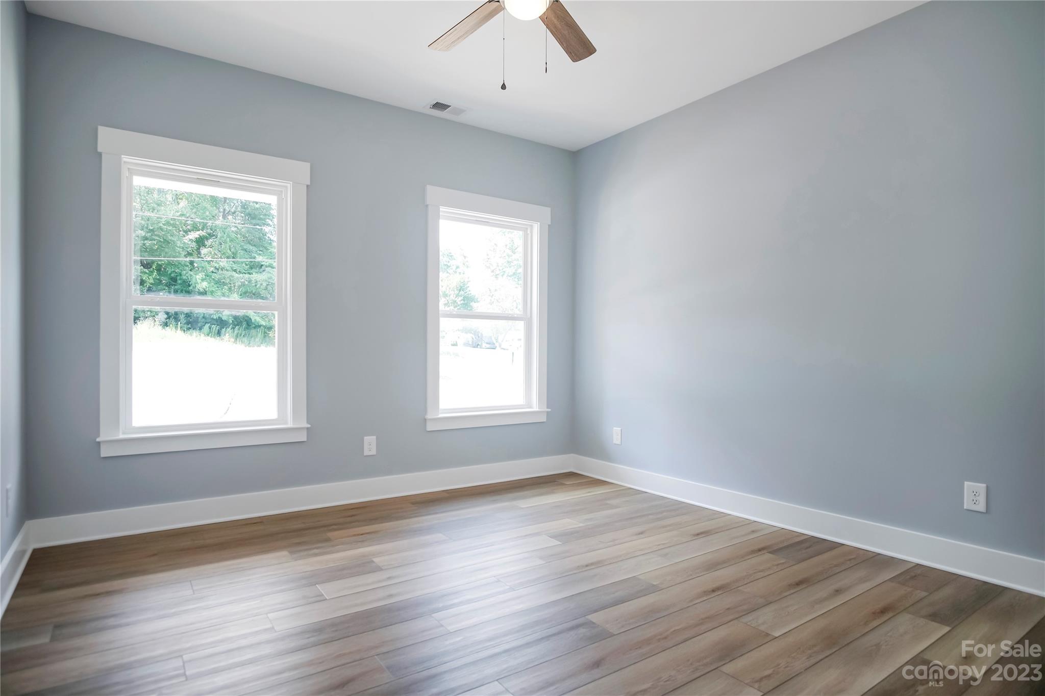 7550 Webbs Road Denver, NC 28037 - Photo 34 of 46 an empty room with wooden floor and windows