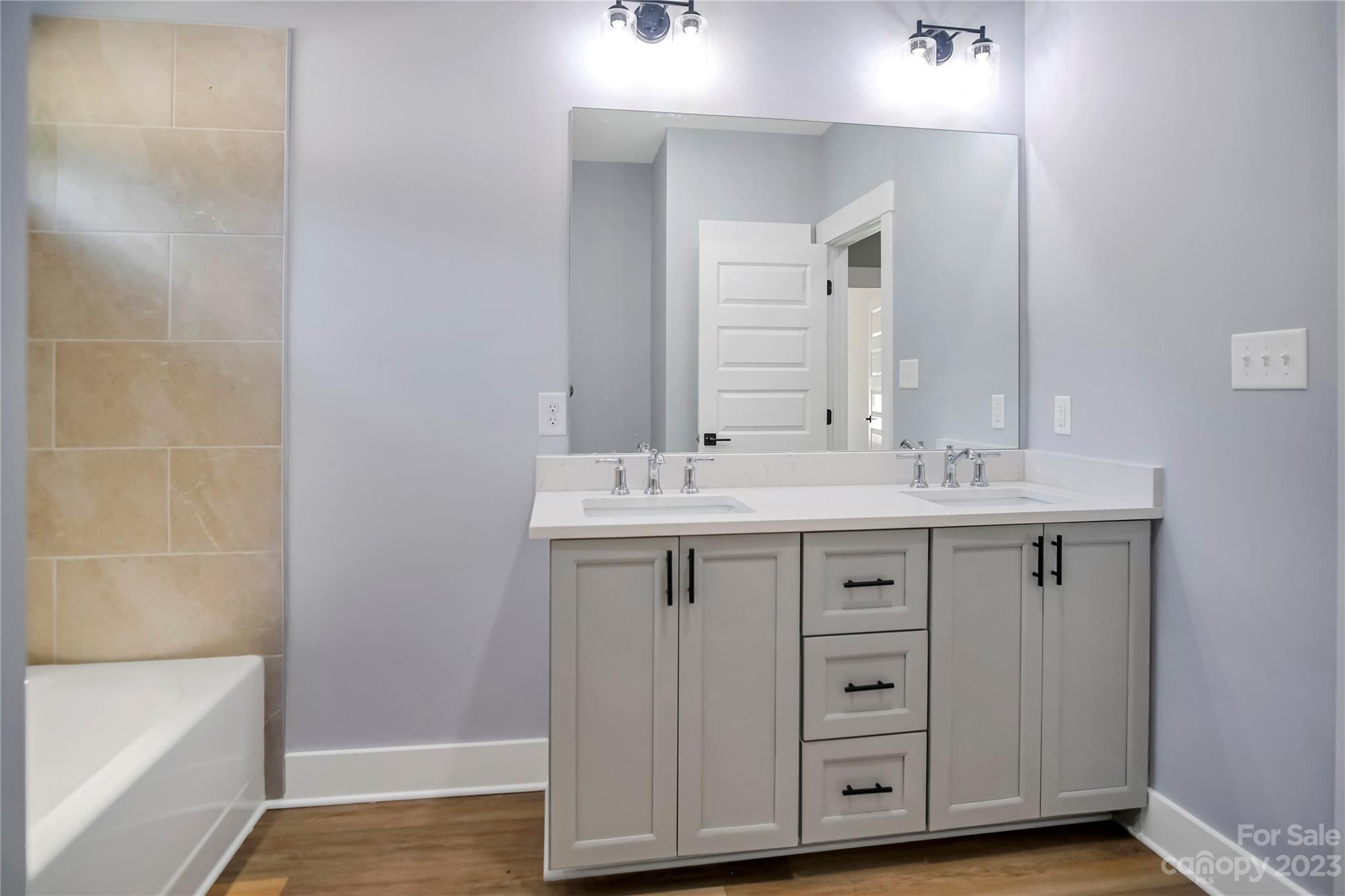 7550 Webbs Road Denver, NC 28037 - Photo 37 of 46 a bathroom with a double vanity sink and a mirror