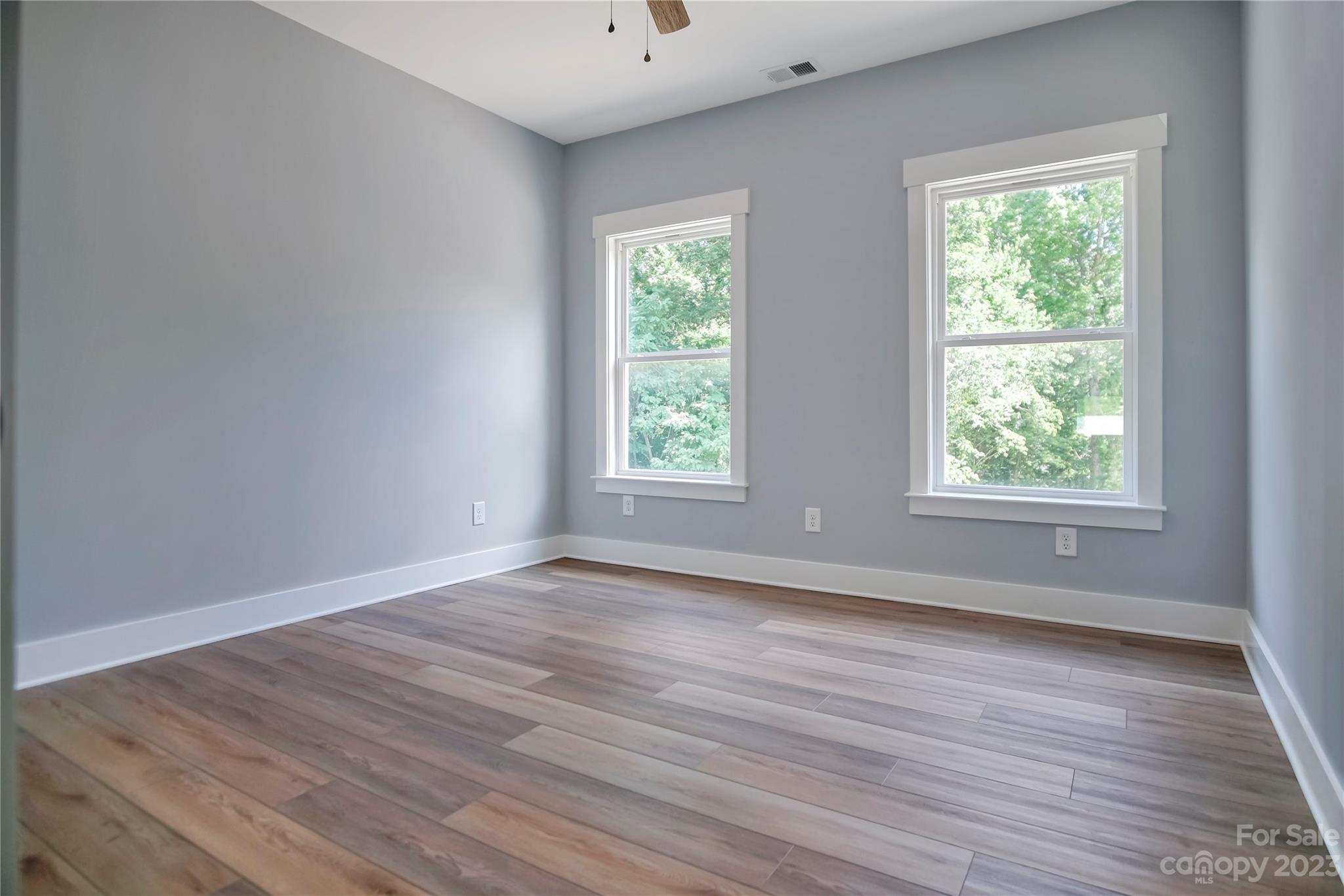 7550 Webbs Road Denver, NC 28037 - Photo 38 of 46 a view of an empty room with wooden floor and a window
