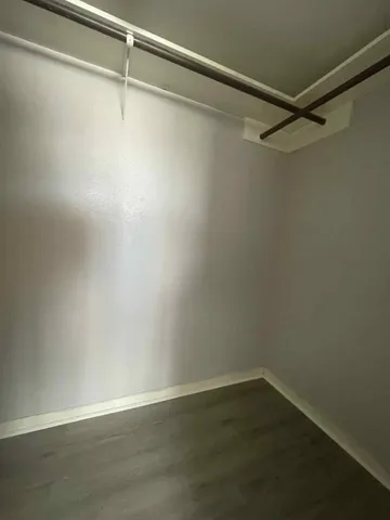 a view of a room with wooden floor