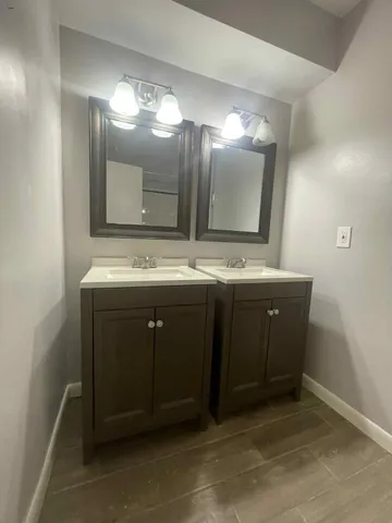 a bathroom with a sink vanity and mirror