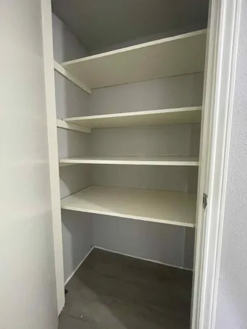 a view of walk in closet with empty racks