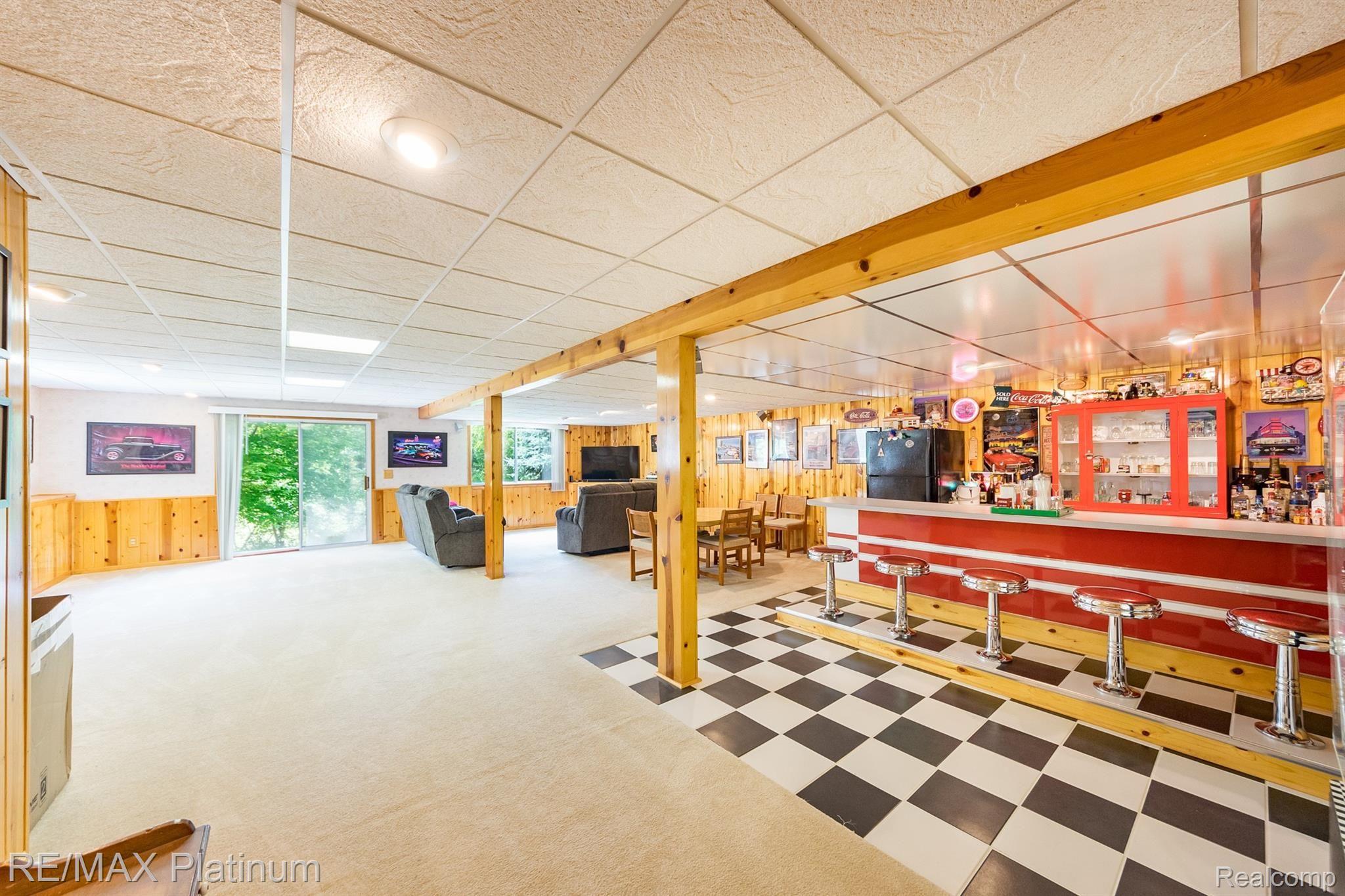 3738 West Schafer Road Pinckney, MI 48169 - Photo 67 of 75 Basement recreation room. Freestanding bar is not included in sale.