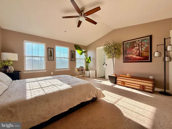 a bedroom with a bed dresser and a window
