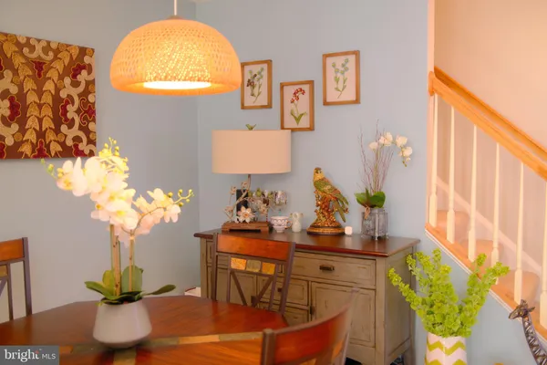 a dining room with furniture and wooden floor